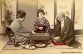 Japón, dos jóvenes japonesas y un anciano jugando al "go". Fotógrafo desconocido
