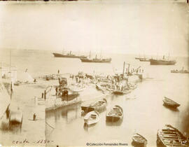 Ceuta, el puerto en obras con operarios, militares y transeuntes, carros y barcos. Fotógrafo desconocido.
